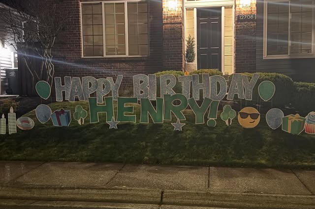Colorful birthday yard-card display installed in a Portland-area lawn