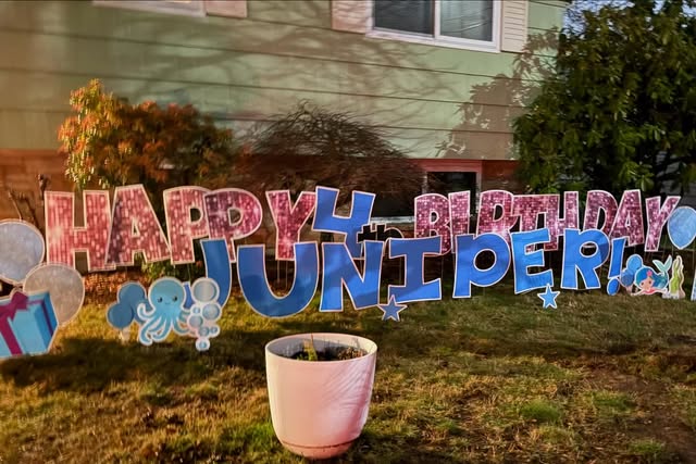 Personalized birthday greeting arranged across a lawn