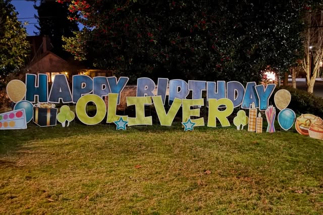 Bright celebratory yard-card letters and graphics